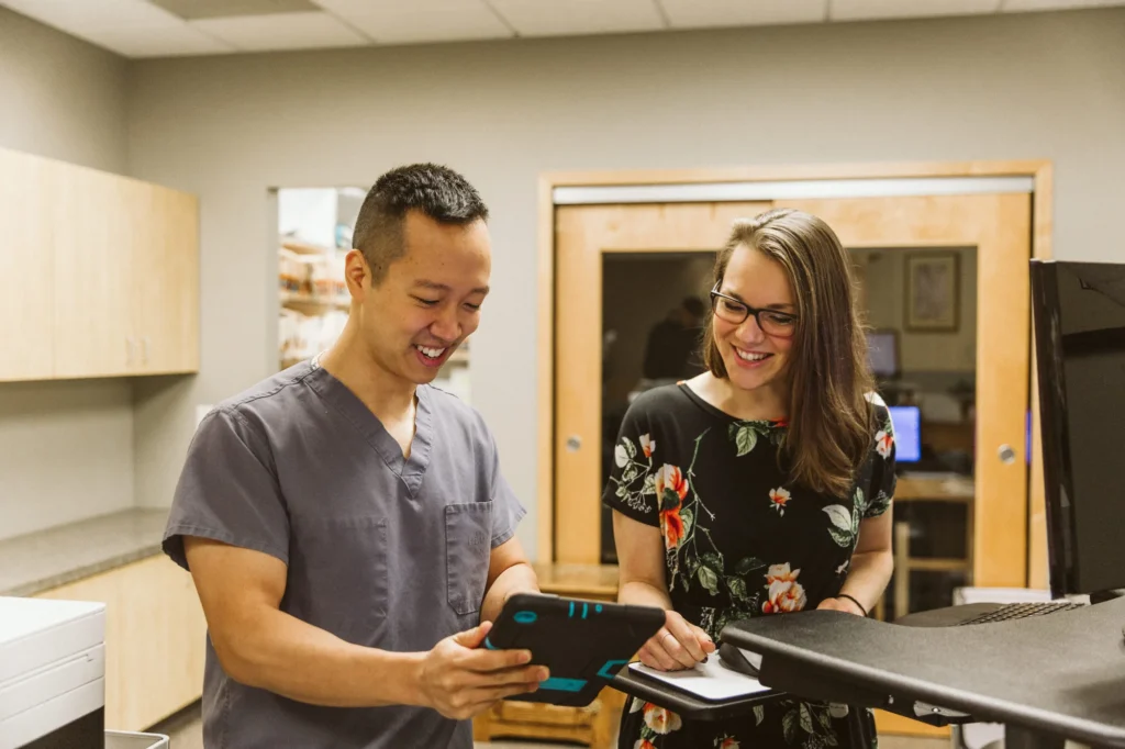 Dr. Cho going over a plan with a patient on a tablet