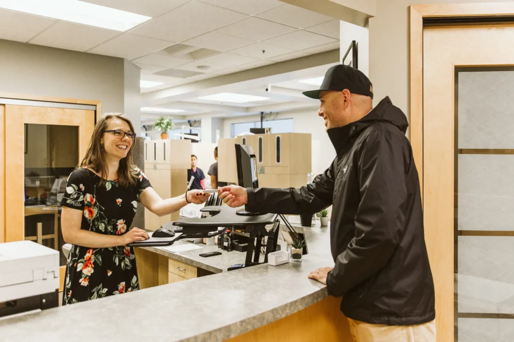 A patient checking in at the front desk