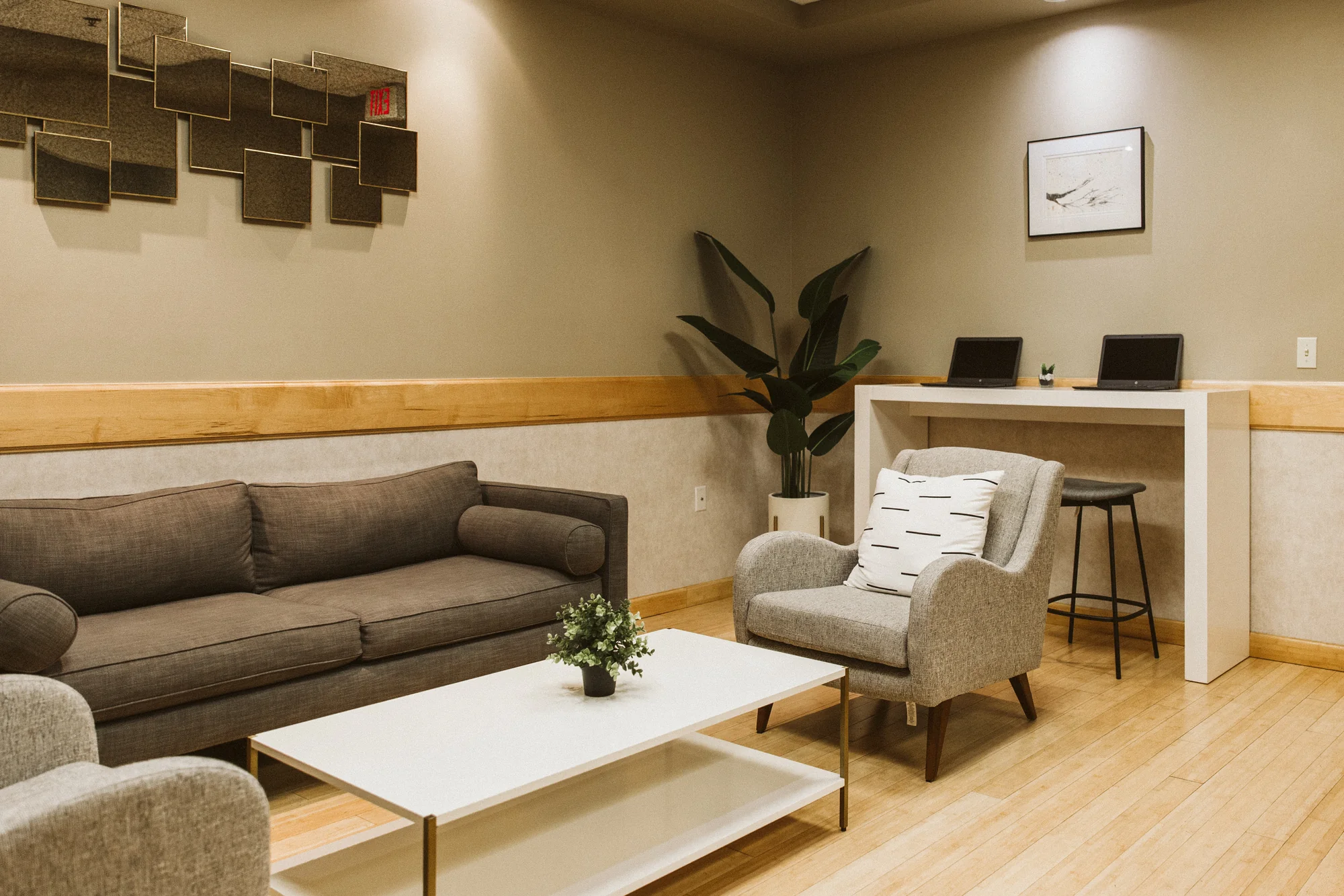 The Life Bloom Dental patient lounge with sofas and armchairs